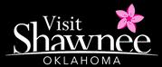 Visit Shawnee logo, black background, pink flower