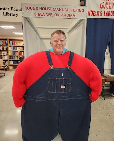 Stephen Koranda in large overalls